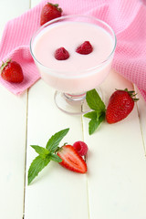 Delicious yogurt with berries on table close-up