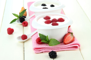 Delicious yogurt with fruit and berries on table close-up