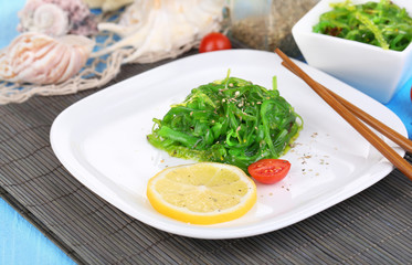 Sea kale on plate on wooden table close-up