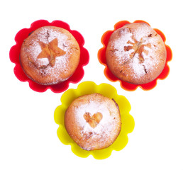 Muffin with icing sugar star, heart and sun in color forms
