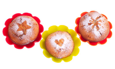 Muffin with icing sugar star, heart and sun in color forms