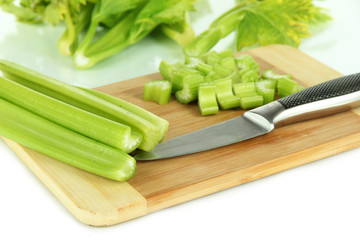 Fresh green celery on cutting board close-up