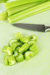 Fresh green celery on cutting board close-up