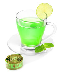 Transparent cup of green tea and measuring tape isolated