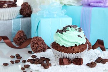 Tasty cupcake with gifts close up