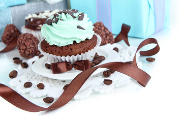 Tasty cupcake with gifts close up