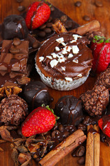 Tasty cupcake with different sweets close up