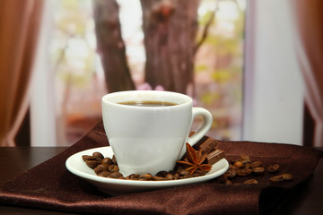cup of coffee with beans on table in cafe