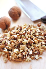 Chopped walnuts on wooden background