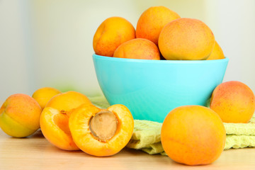 Fresh natural apricot in bowl on table in kitchen