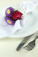 Festive dining table setting with flowers isolated on white