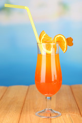 Tasty cocktail on swimming pool background