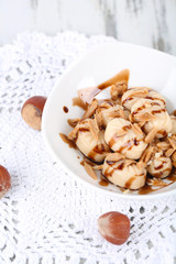 Many toffee in bowl on napkin close-up