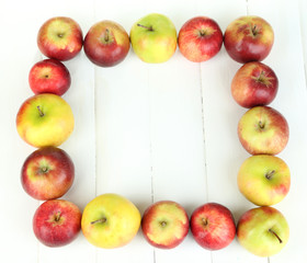 Juicy apples on white wooden table