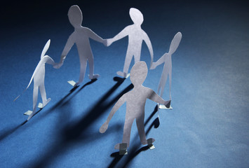 Paper people in social network concept on dark background