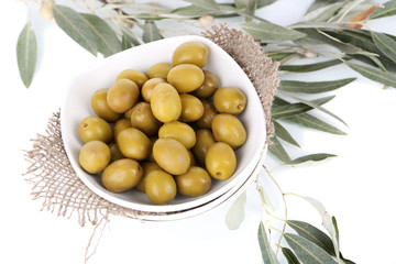 Olives in bowl with branch close up