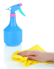 Hand wiping surface with yellow rag and spray isolated on white