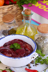 Raw liver in pan with spices and condiments