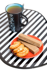 A cup of tea, cakes and wafer
