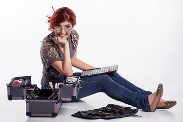 Happy make-up artist surrounded by her tools