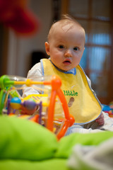 Surprised baby with toys