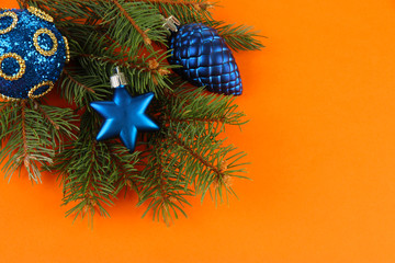Beautiful Christmas decorations on fir tree on orange