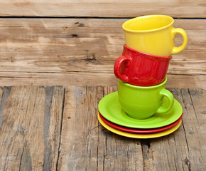 Colorful coffee cups on wooden table