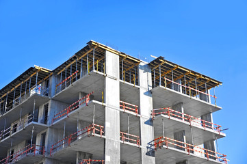 Building construction site work against blue sky