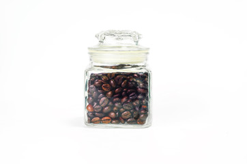 Coffee beans in a bottle on white background..