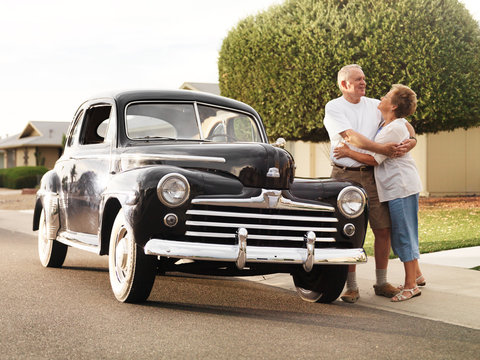 senior couple with vintage car