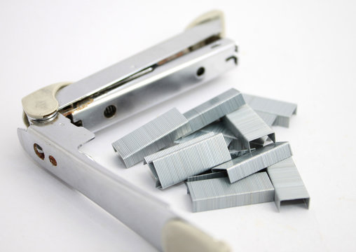 Stapler and staples isolated on white