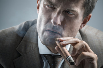 Elegant adult man smoking a cigar