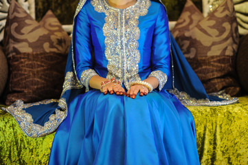 Bride Wearing a blue dress sitting on an altar, head not seen