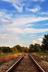 Fototapeta na wymiar Picturesque autumn rural landscape with railway track.