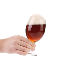 Closeup of beer glass in hand.