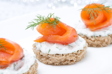 festive appetizer - canape with rye bread, cream cheese, salmon