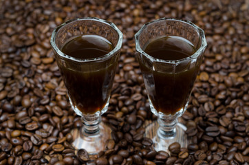two shot glasses of coffee liqueur, selective focus horizontal