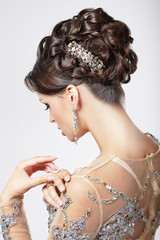 Elegance. Chic. Beautiful Brunette with Classy Hairstyle. Luxury