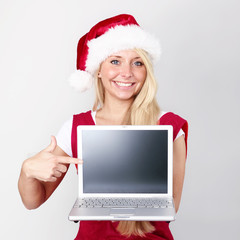 Santa pointing at laptop with copyspace