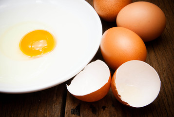 broken chicken eggs and egg yolk