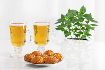 Tea in glass cups and tasty cookies