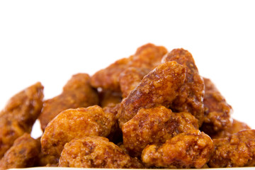 Burnt almonds isolated on white background