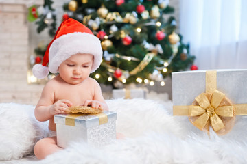 Kid in Santa hat, in a holiday room