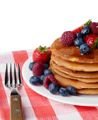 Pancakes with berries and honey over white
