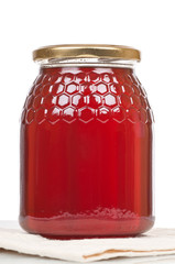 Jar of honey over a white background