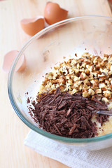 Chopped chocolate and walnuts in glass bowl