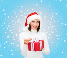 smiling woman in santa helper hat with gift box