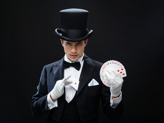 magician showing trick with playing cards