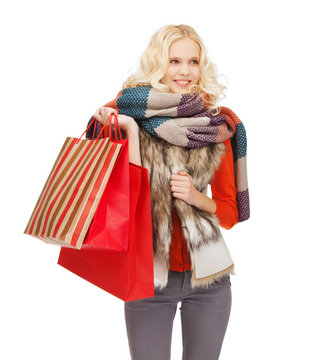 teenage girl in winter clothes with shopping bags
