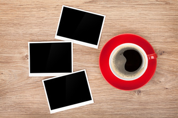 Obraz na płótnie Canvas Cup of coffee and three photo frames